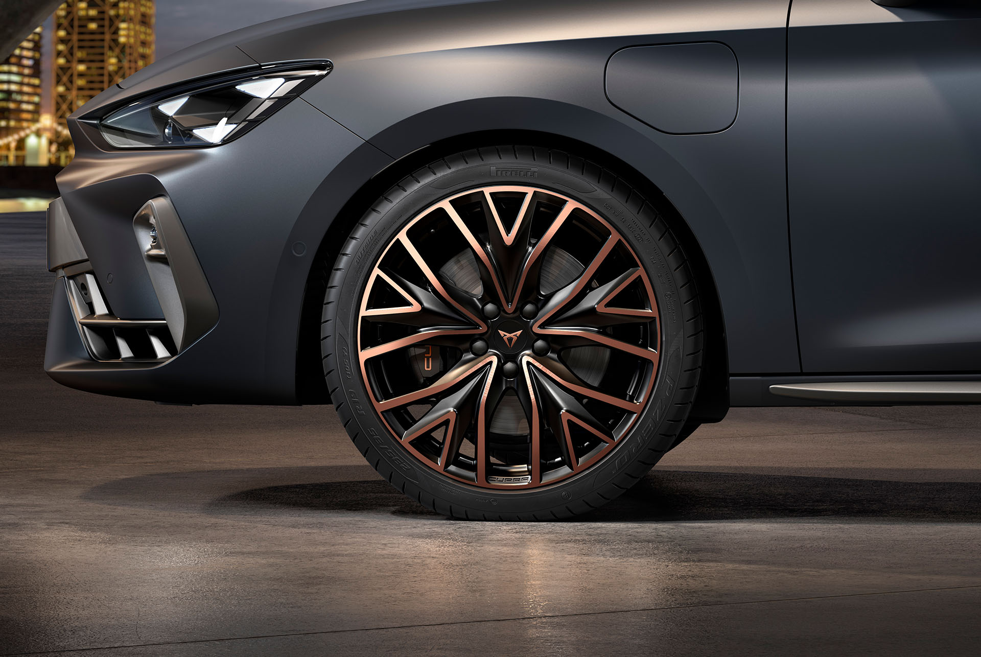 front side view of left mstral copper forged wheels in copper and black for the new cupra leon sportstourer 2025, tyres, signature headlights and grey body