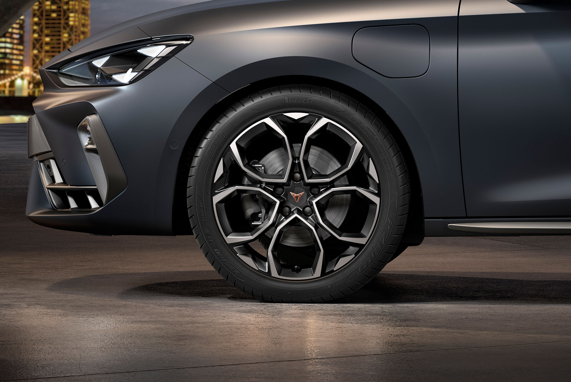 front side view of left machined silver and black windstorm alloy wheel for the new cupra leon sportstourer 2025, tyres, signature headlights and grey body
