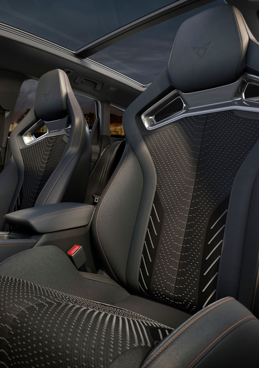 new Cupra Leon Sportstourer 2025 interior, extreme equipment pack, central console, cup bucket seats, sennheiser speakers and more. Sunset outside of window.