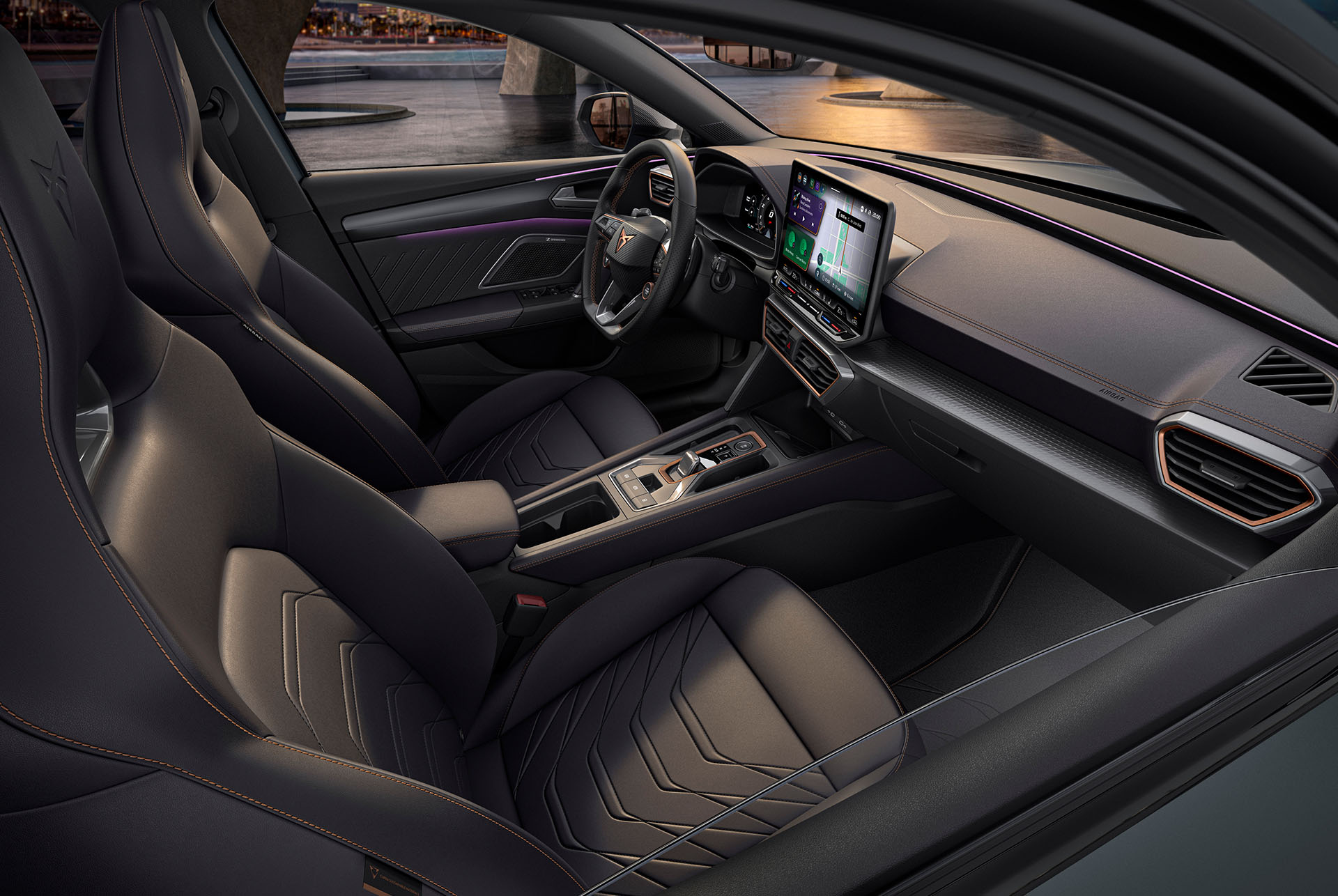 Interior of new grey Cupra Leon Sportstourer 2025, front passenger and driver seats, infotainment system, cupra wheel, bucket seats, at sunset.