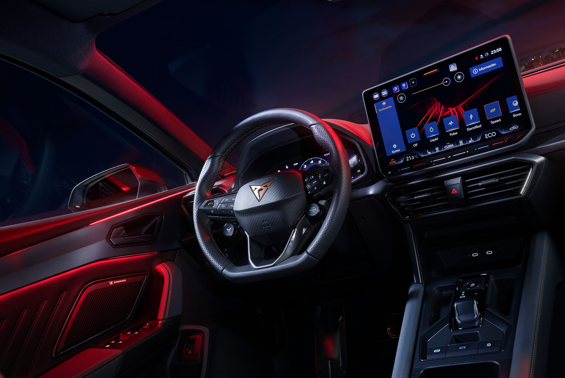 the interior of a CUPRA Leon. The dashboard is dominated by a large, high-resolution touchscreen display. The steering wheel features the distinctive CUPRA logo and has a sporty, flat-bottomed design. The overall impression is one of a high-tech and luxurious driving environment.