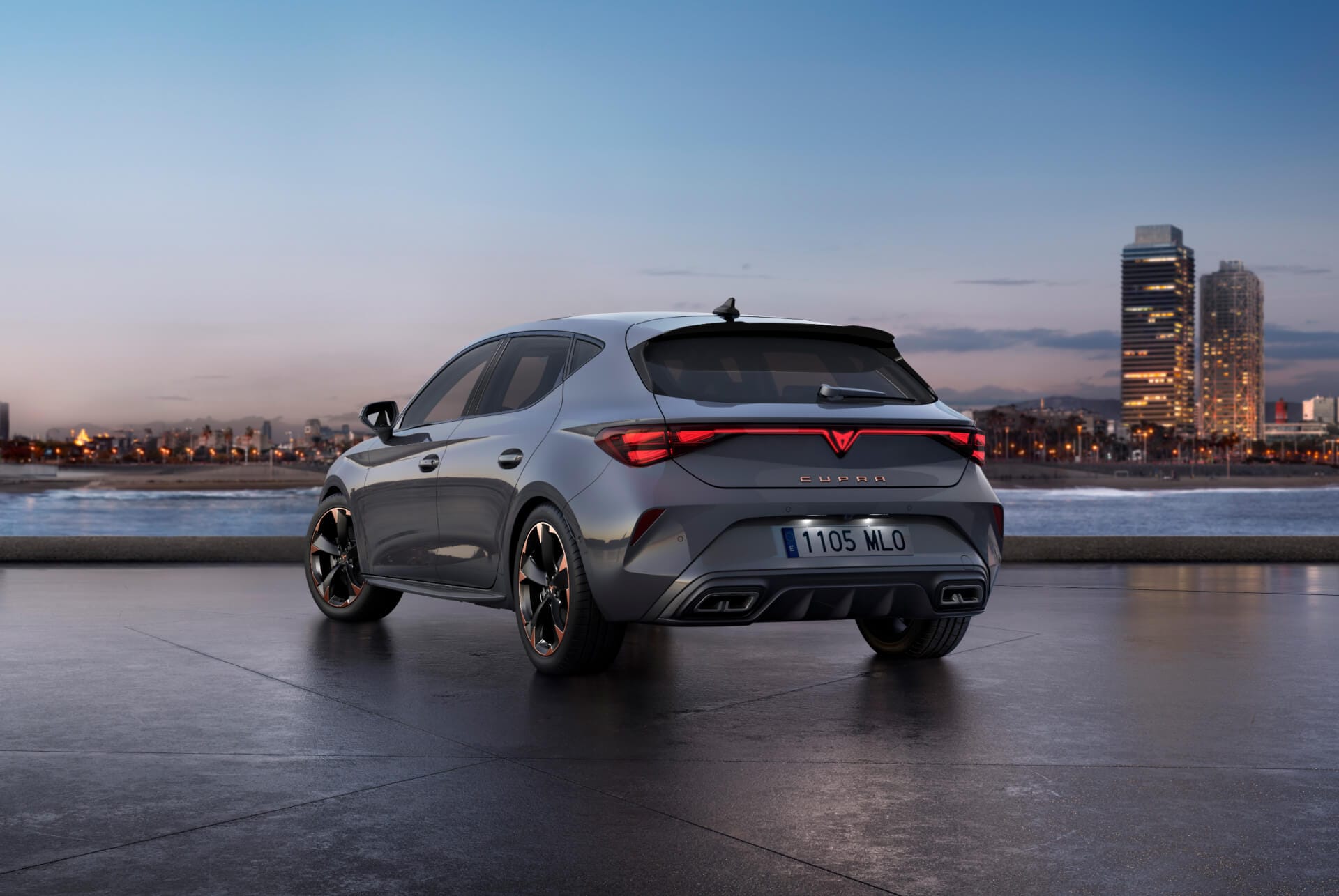 Rear view shot of new cupra leon 2025 glossy grey car model with dynamic chassis control, plus black and copper alloy wheels. City in the background at sunset.