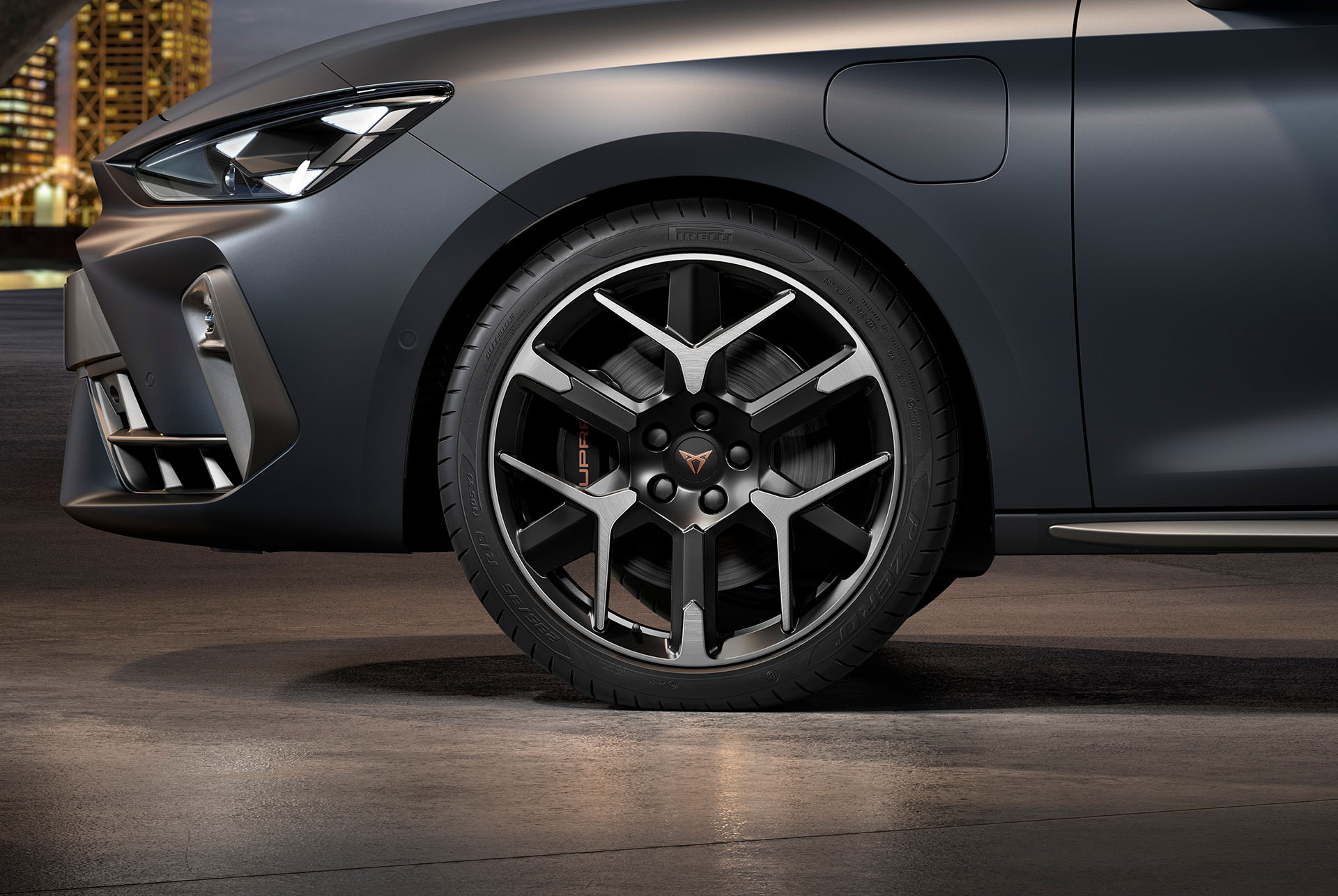 : front side view of left forged wheel in silver and black for the new cupra leon 2025, tyres, signature headlights and matt grey car body