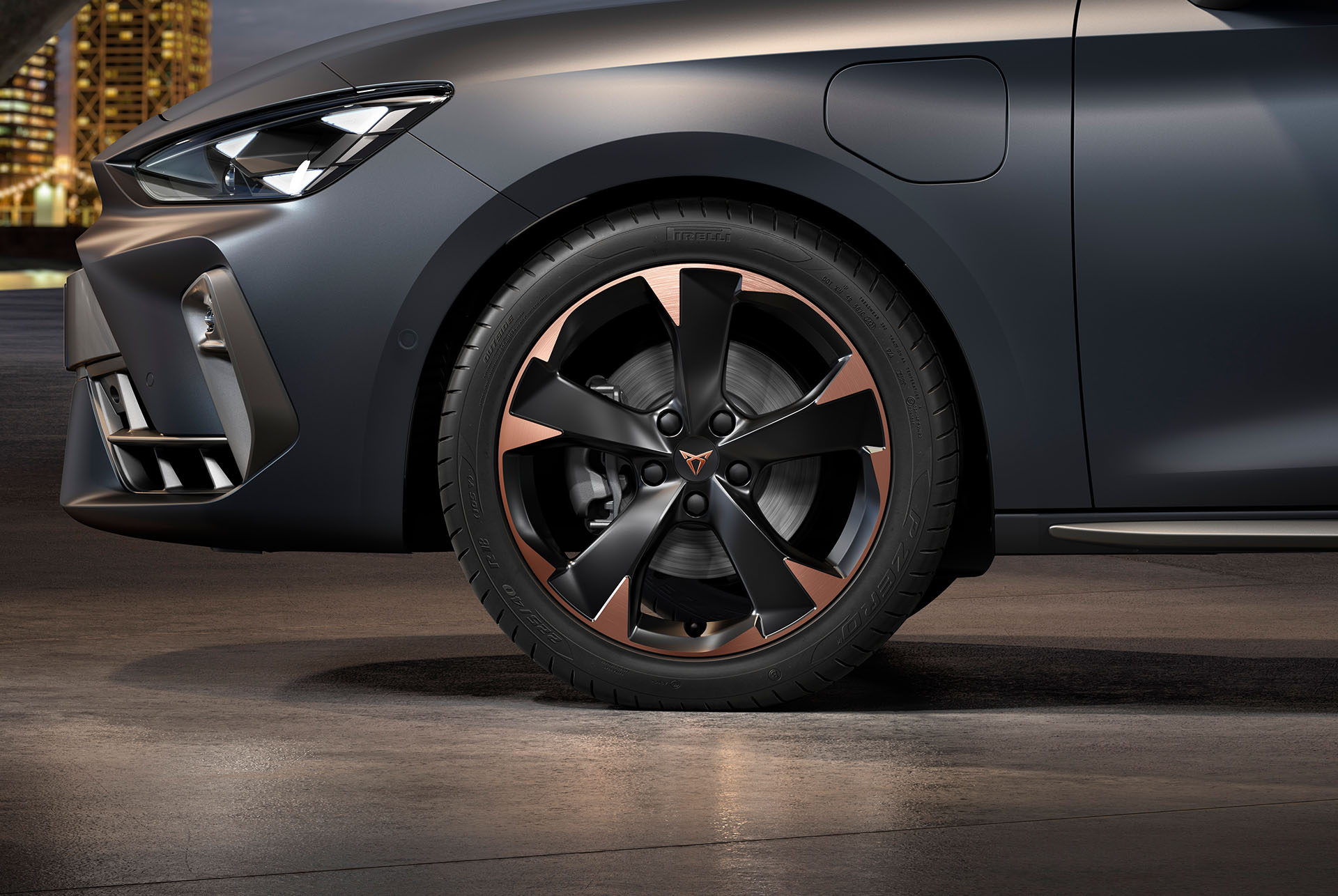 front side view of left mistral garbi copper machined alloy wheels for the new cupra leon sportstourer 2025, tyres, signature headlights and matt grey body