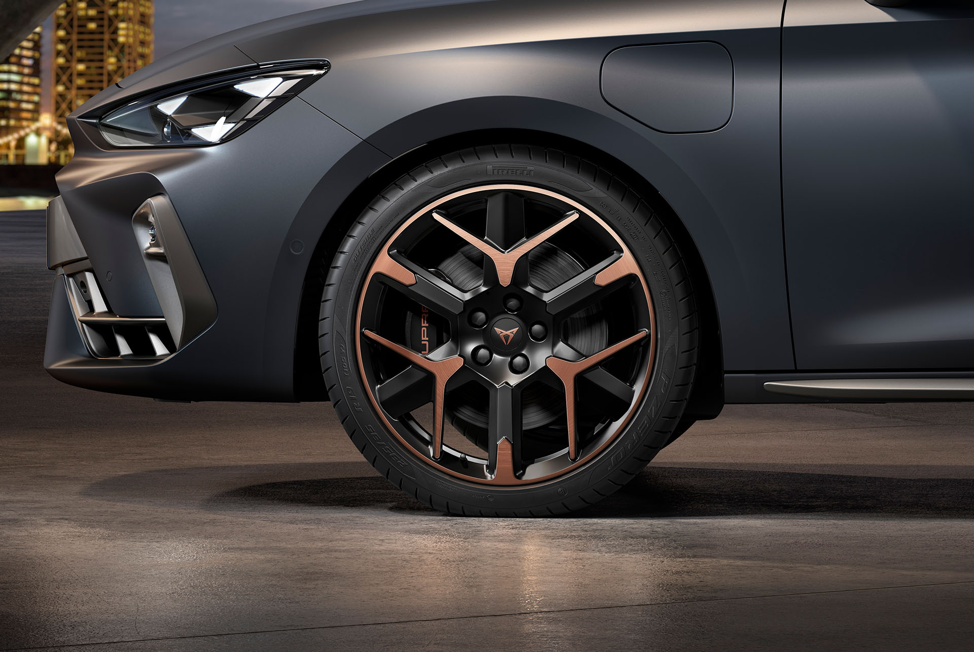 front side view of left forged alloy wheel in copper and black for the new cupra leon 2025, tyres, signature headlights and matt grey body