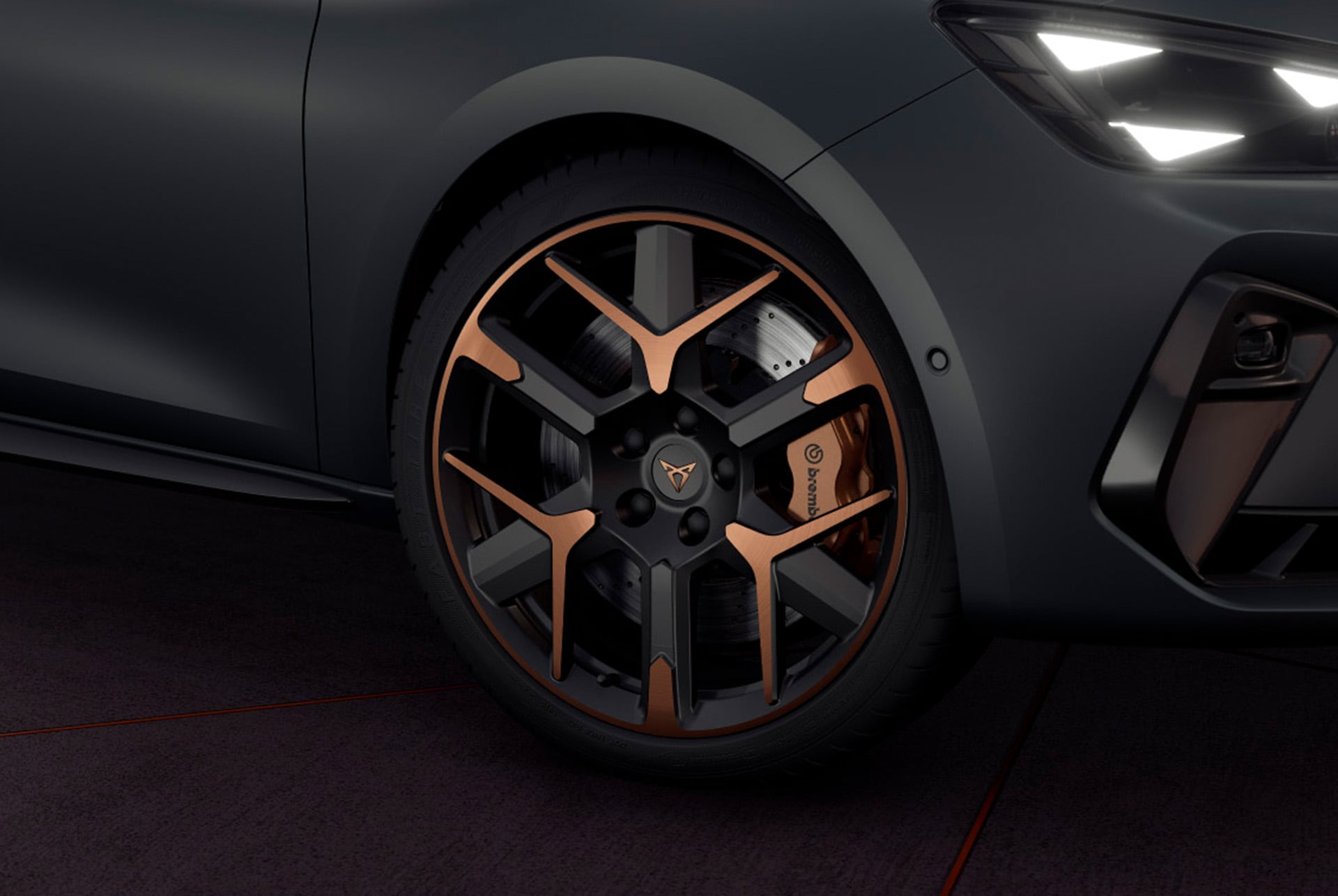 close up of new cupra leon 2025 hailstorm copper accent and black forged wheels with a triangle eye headlight