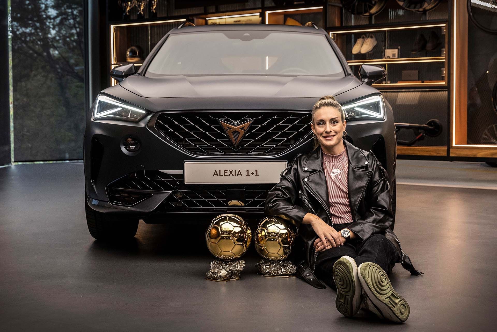 alexia putellas sitting in front of black cupra formentor vehicle