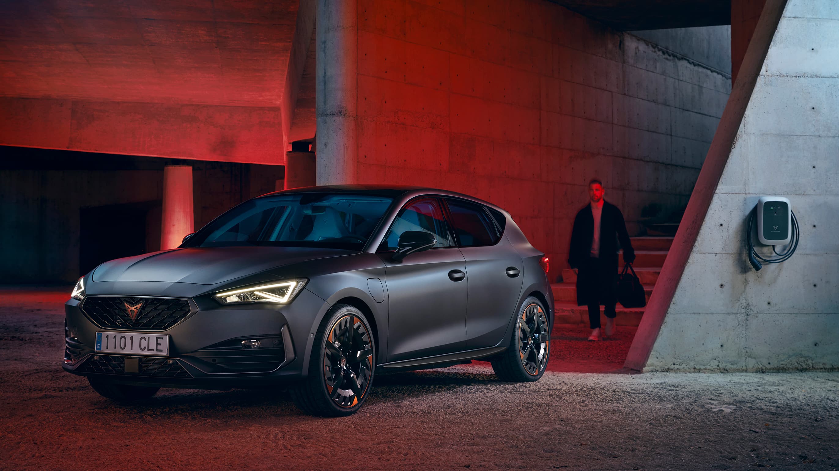 new CUPRA Leon ehybrid five door magnetic tech matte compact sports car side view charging 